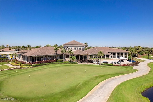 view of home's community with golf course view and a patio