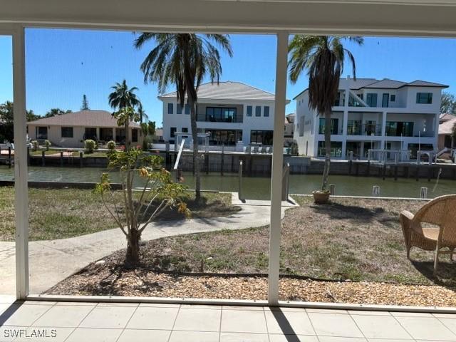 view of yard with a residential view and a water view