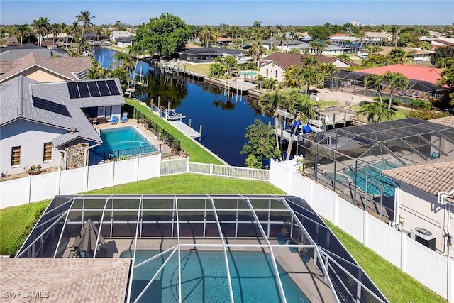 view of swimming pool featuring a fenced backyard, a residential view, and a water view