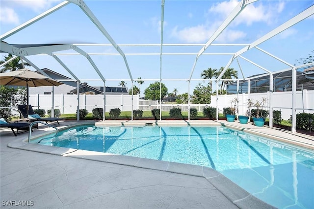 view of pool with a patio, a fenced backyard, a fenced in pool, and a lanai