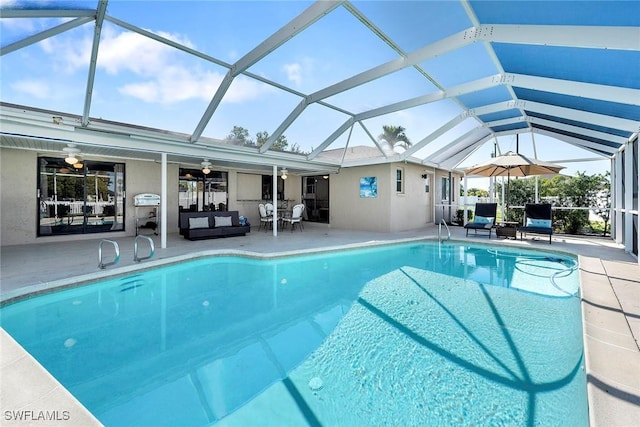 pool with a patio area, an outdoor hangout area, a lanai, and a ceiling fan