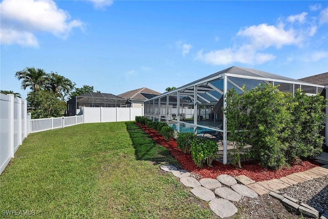 view of yard featuring a lanai, a fenced in pool, and a fenced backyard