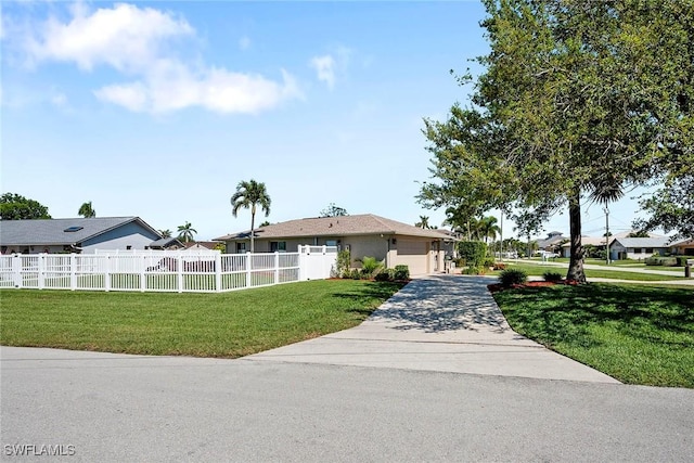 single story home featuring a fenced front yard, driveway, a garage, and a front yard