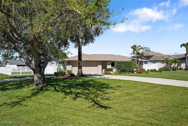 ranch-style house with a front yard, fence, a garage, and driveway