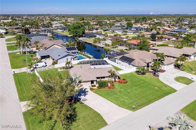 drone / aerial view with a residential view and a water view