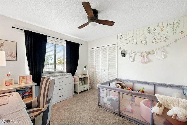 office area with light carpet, a textured ceiling, and ceiling fan