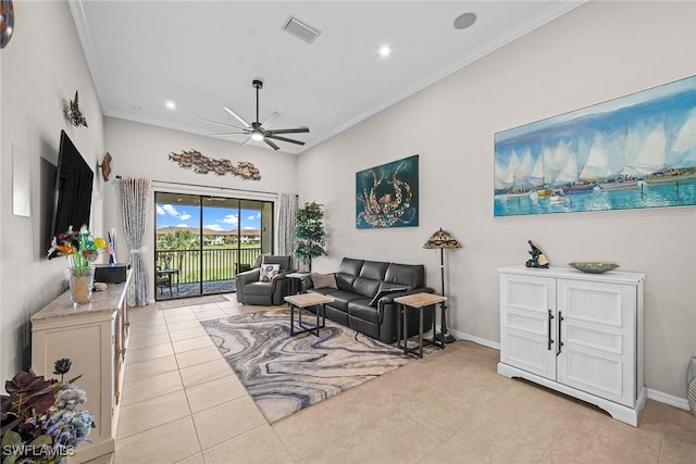 living area with light tile patterned floors, baseboards, visible vents, ceiling fan, and ornamental molding