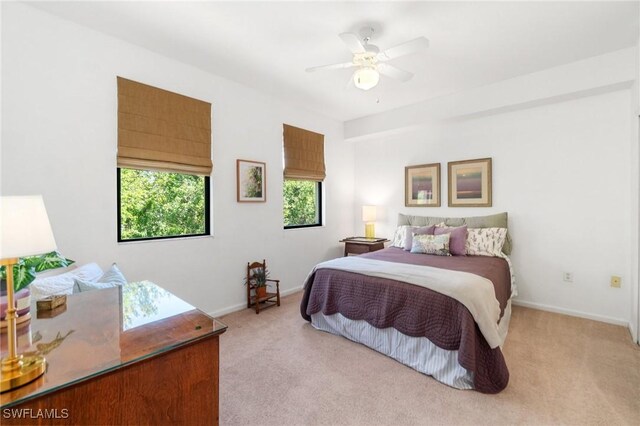 bedroom featuring baseboards, ceiling fan, and light colored carpet