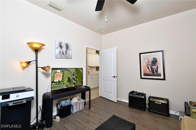 interior space featuring visible vents, baseboards, and wood finished floors