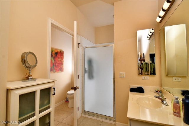 bathroom with vanity, baseboards, a shower stall, tile patterned floors, and toilet