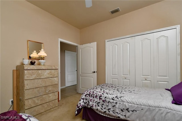 bedroom with visible vents, light carpet, a closet, and ceiling fan