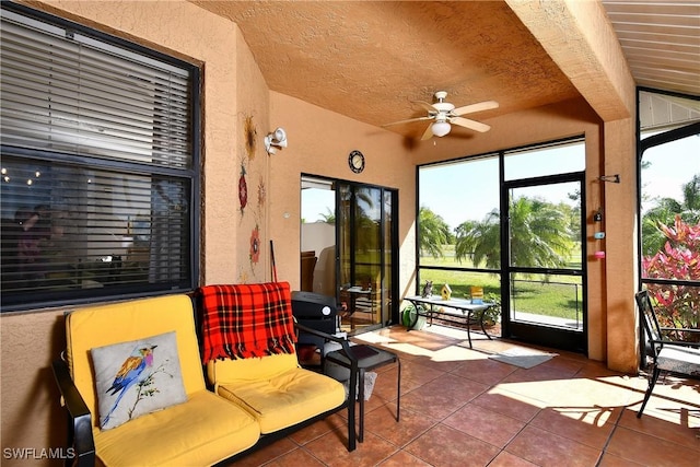 sunroom featuring a ceiling fan