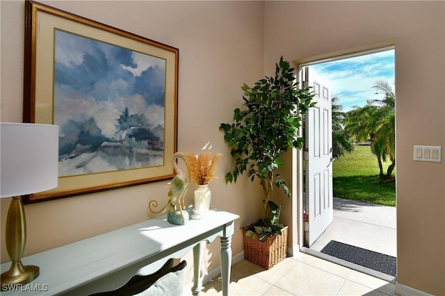 entryway with light tile patterned floors and baseboards