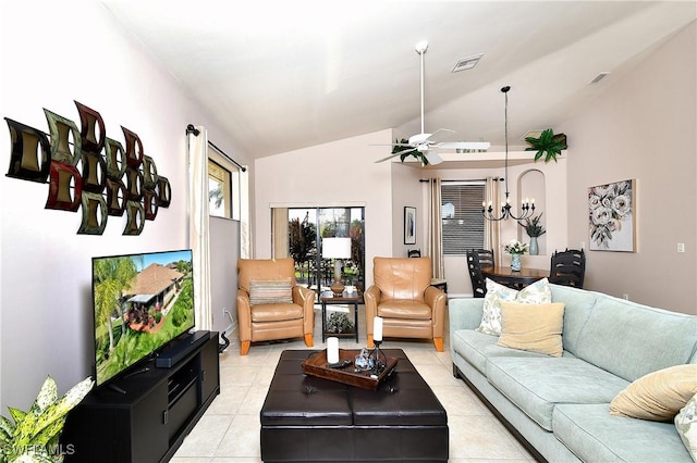 living area with lofted ceiling, light tile patterned floors, ceiling fan with notable chandelier, and visible vents