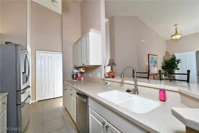 kitchen featuring light countertops, light tile patterned floors, stainless steel appliances, high vaulted ceiling, and a sink