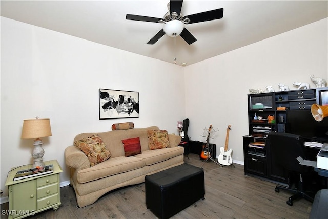 living room with baseboards, wood finished floors, and a ceiling fan