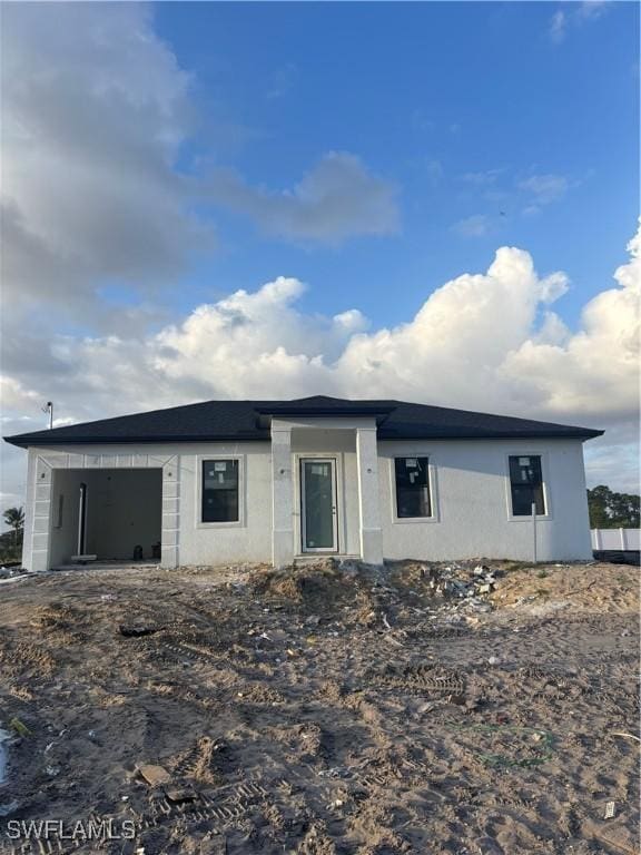 view of front of property with an attached garage and stucco siding