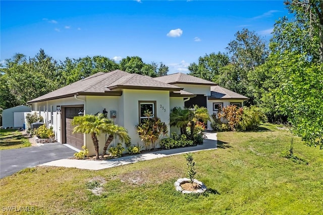 view of front of house featuring aphalt driveway, stucco siding, an attached garage, and a front yard