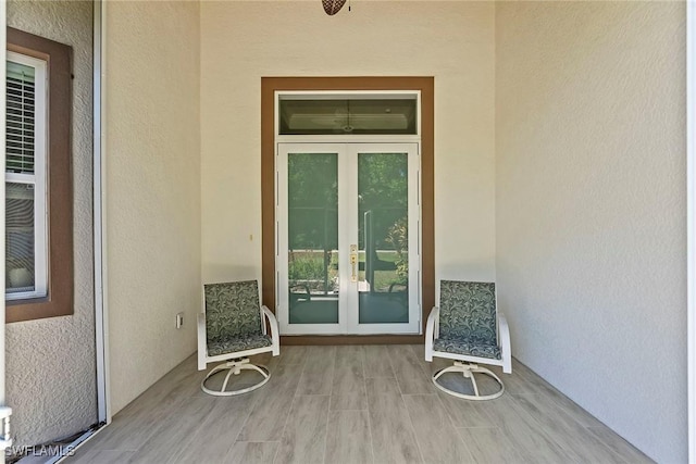 entrance to property with french doors and stucco siding