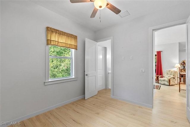 unfurnished bedroom with visible vents, baseboards, light wood-style flooring, and a ceiling fan