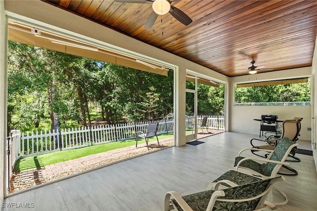 view of patio featuring a ceiling fan and fence