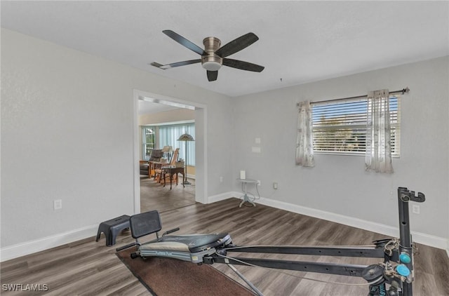 workout room featuring visible vents, a healthy amount of sunlight, baseboards, and wood finished floors