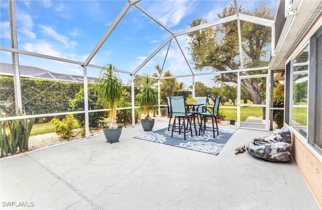 view of patio / terrace featuring glass enclosure