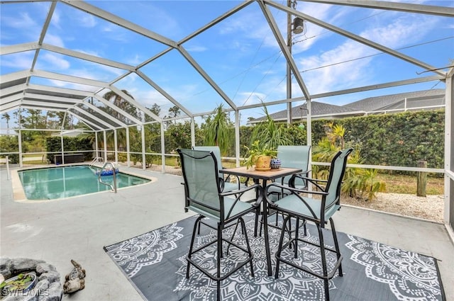 pool featuring glass enclosure and a patio area