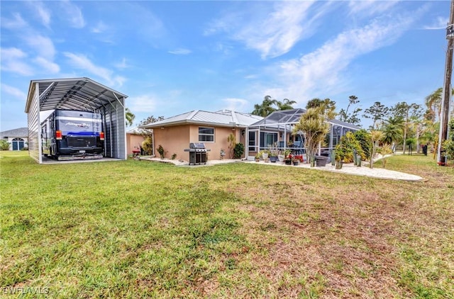 rear view of house featuring glass enclosure, a detached carport, a patio, stucco siding, and a lawn