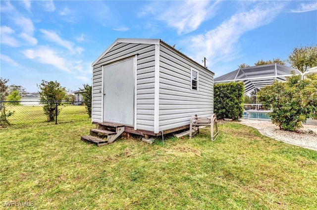 view of shed featuring a fenced in pool and fence