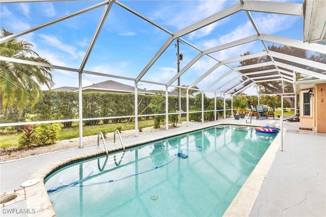 outdoor pool with glass enclosure and a patio