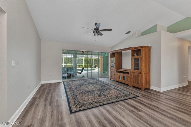 unfurnished living room featuring visible vents, baseboards, vaulted ceiling, wood finished floors, and a ceiling fan