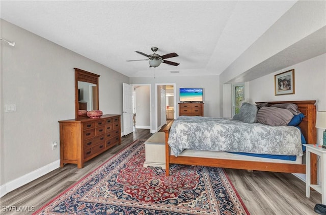 bedroom with visible vents, ceiling fan, baseboards, and wood finished floors