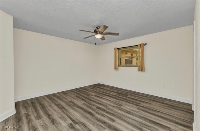 spare room with dark wood finished floors, a ceiling fan, baseboards, and a textured ceiling