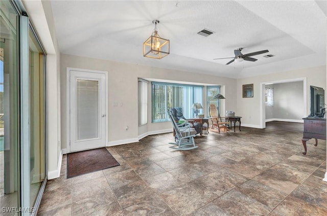 entryway with visible vents, baseboards, and ceiling fan with notable chandelier