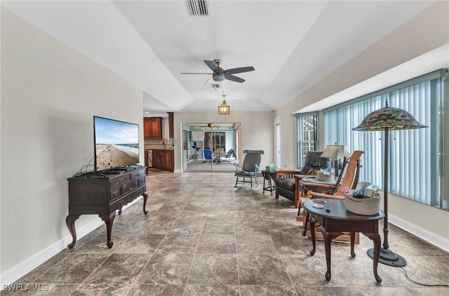 sitting room with visible vents, baseboards, and ceiling fan