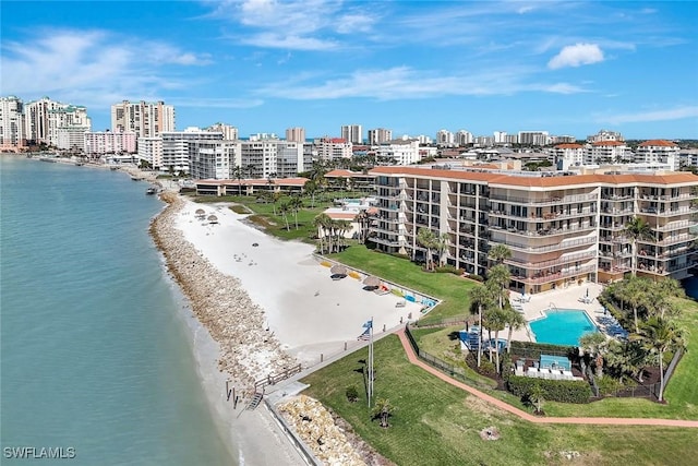 birds eye view of property featuring a view of city, a view of the beach, and a water view