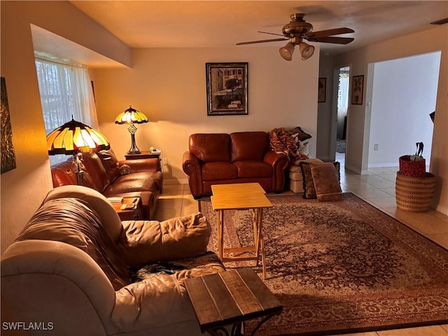 living area with tile patterned floors, baseboards, and ceiling fan