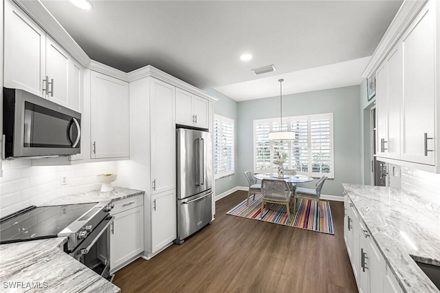 kitchen featuring backsplash, appliances with stainless steel finishes, dark wood-style floors, and white cabinetry