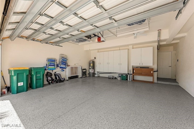 garage with water heater and a garage door opener