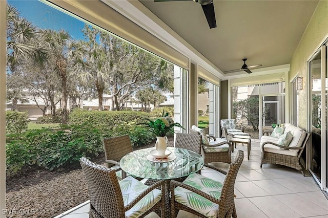 sunroom / solarium featuring ceiling fan