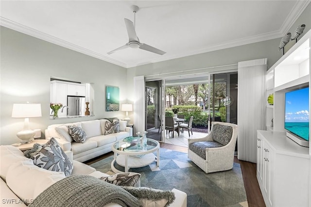 living room featuring dark wood finished floors, crown molding, and a ceiling fan