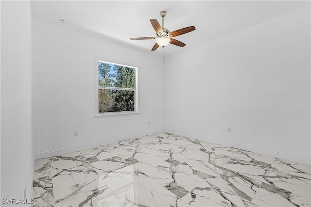 empty room featuring baseboards and a ceiling fan