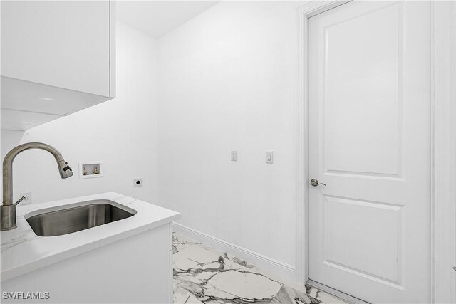 laundry area featuring laundry area, marble finish floor, hookup for an electric dryer, and a sink