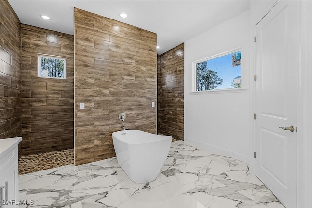 full bath with recessed lighting, marble finish floor, a freestanding bath, and walk in shower