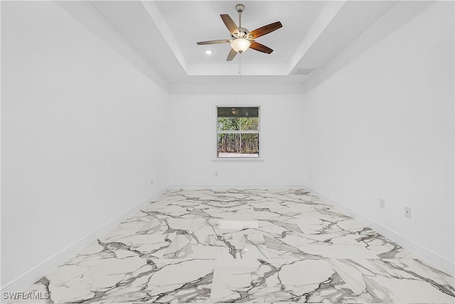 empty room featuring visible vents, recessed lighting, baseboards, and a tray ceiling