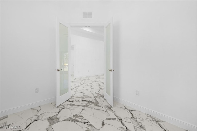 corridor with visible vents, marble finish floor, and baseboards