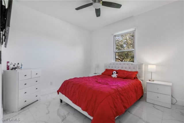 bedroom featuring marble finish floor, a ceiling fan, and baseboards