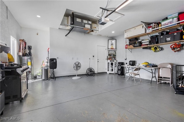 garage featuring water heater, recessed lighting, and a garage door opener