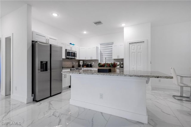 kitchen with visible vents, tasteful backsplash, marble finish floor, and appliances with stainless steel finishes